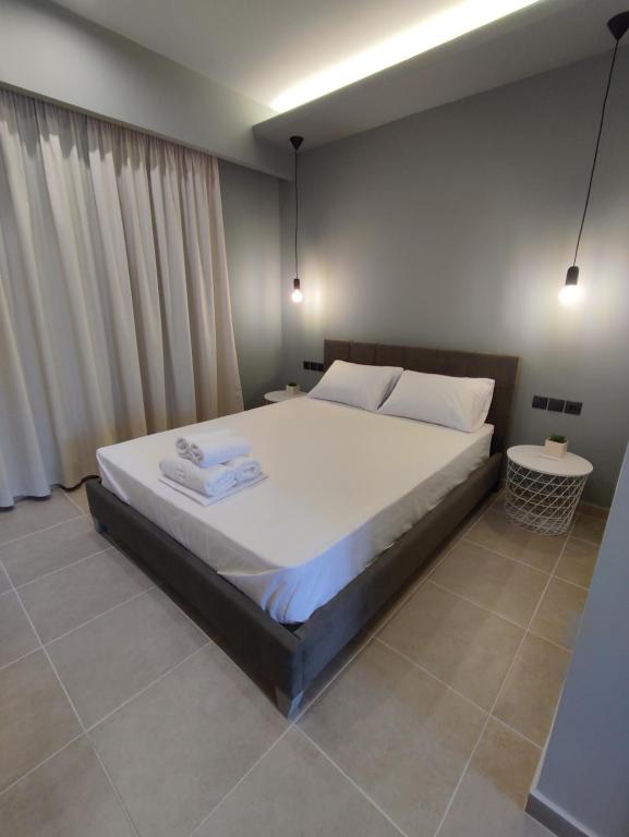 邁薩納的住宿－Stefani apartments，卧室配有一张带白色床单和枕头的大床。