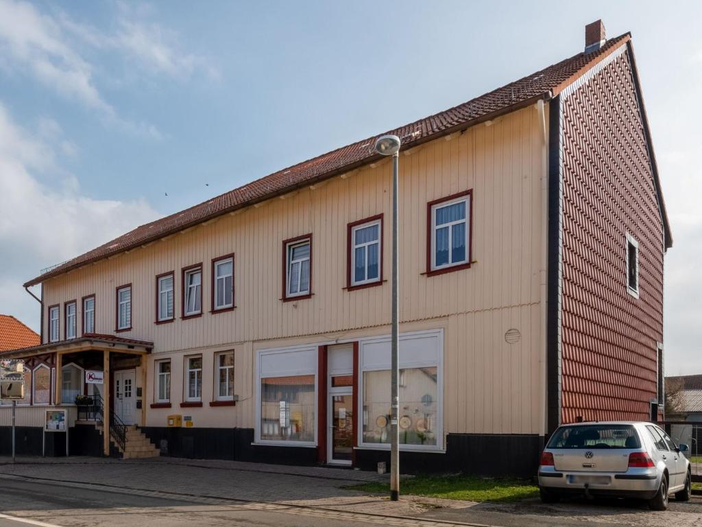 un bâtiment avec une voiture garée devant lui dans l'établissement Bright apartment in Harz Mountains, à Cattenstedt