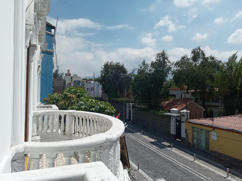 a white balcony with a view of a city at El MONARCA AREQUIPA in Arequipa