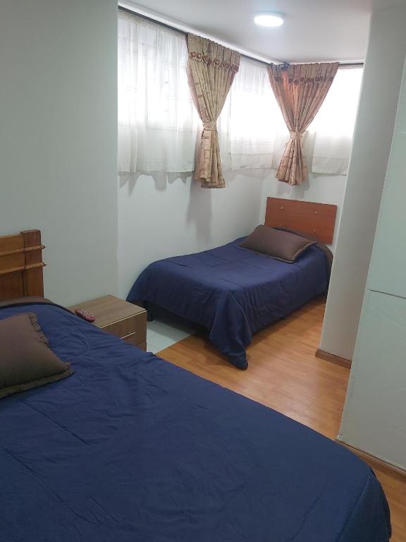 Postel nebo postele na pokoji v ubytování Hospedaje Sary House
