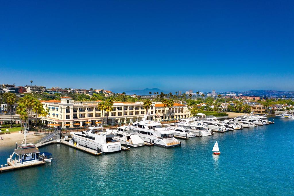 boats are docked in the water near a city at Balboa Bay Resort in Newport Beach