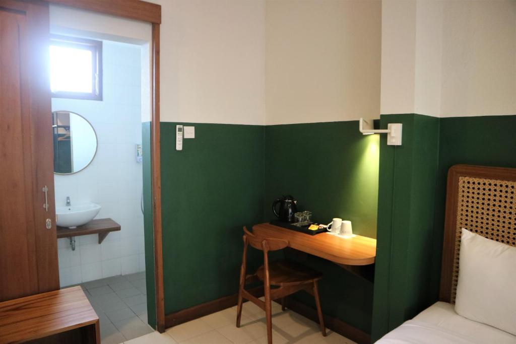 Postel nebo postele na pokoji v ubytování Liberta Malioboro South