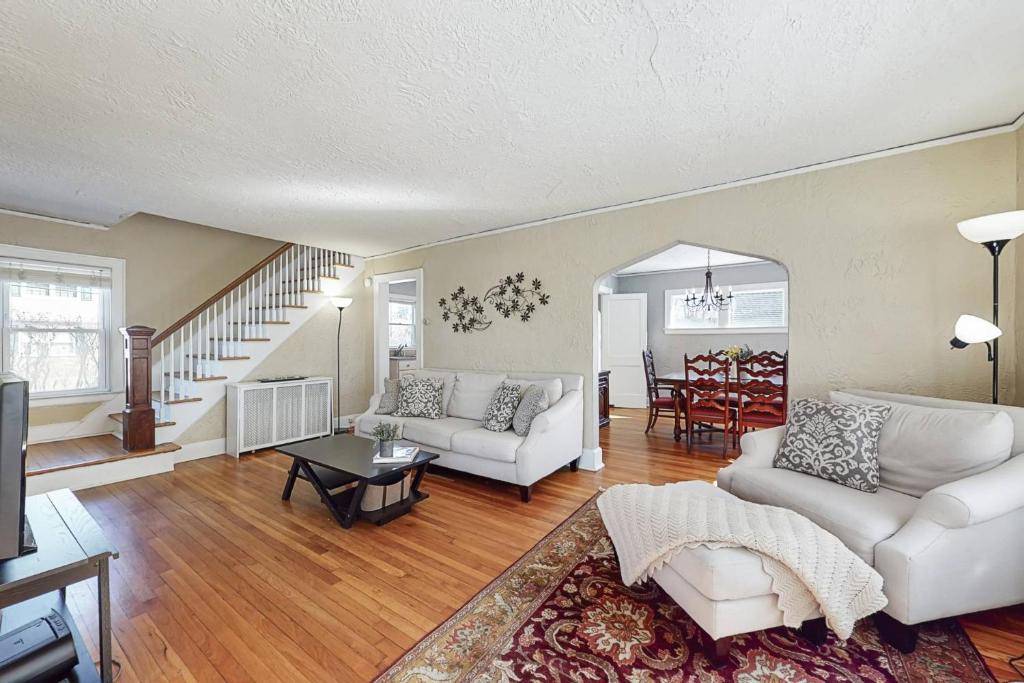 a living room with two white couches and a table at Belltown Retreat in Stamford