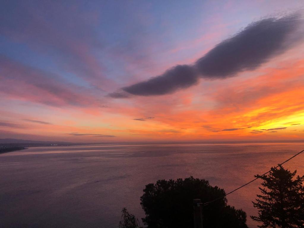 a sunset over a body of water at Luna Convento Copanello B&B in Stalettì