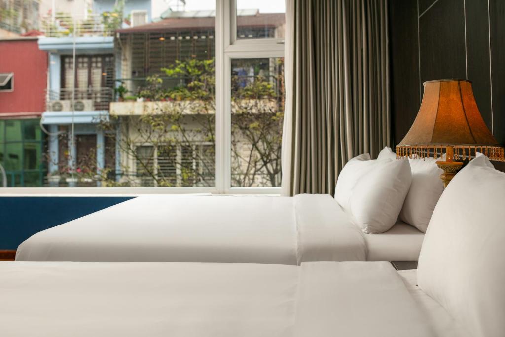 Postel nebo postele na pokoji v ubytování Hanoi 20 Hotel & Apartment