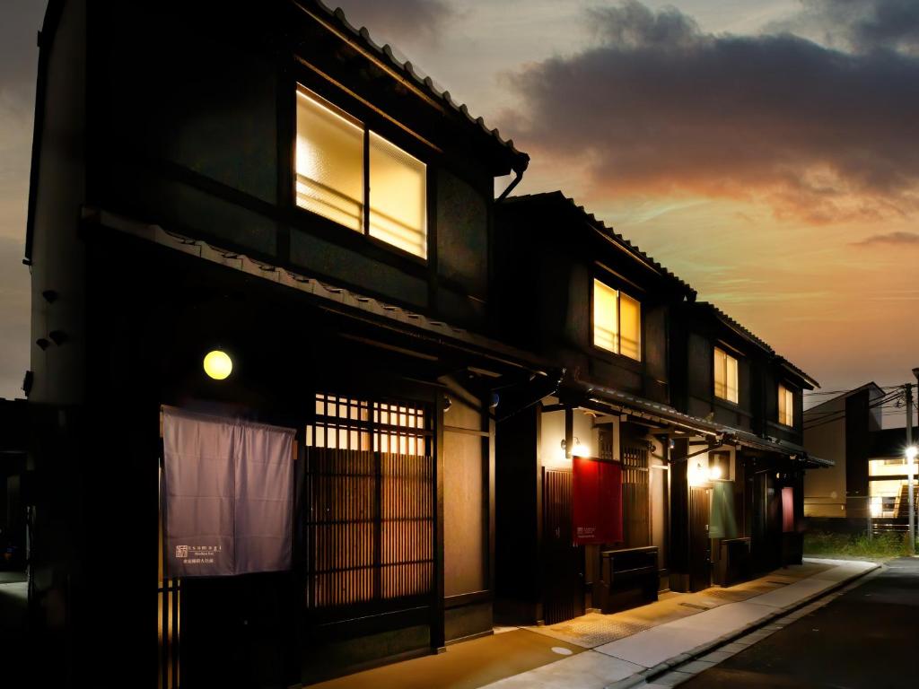 a building with lit up windows at night at Kanade Fushimiinari-Taishame in Kyoto