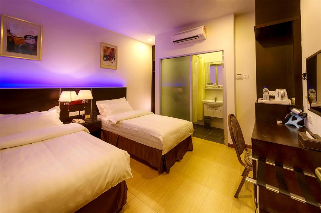 Postel nebo postele na pokoji v ubytování ERNES Hotel Alma Bukit Mertajam