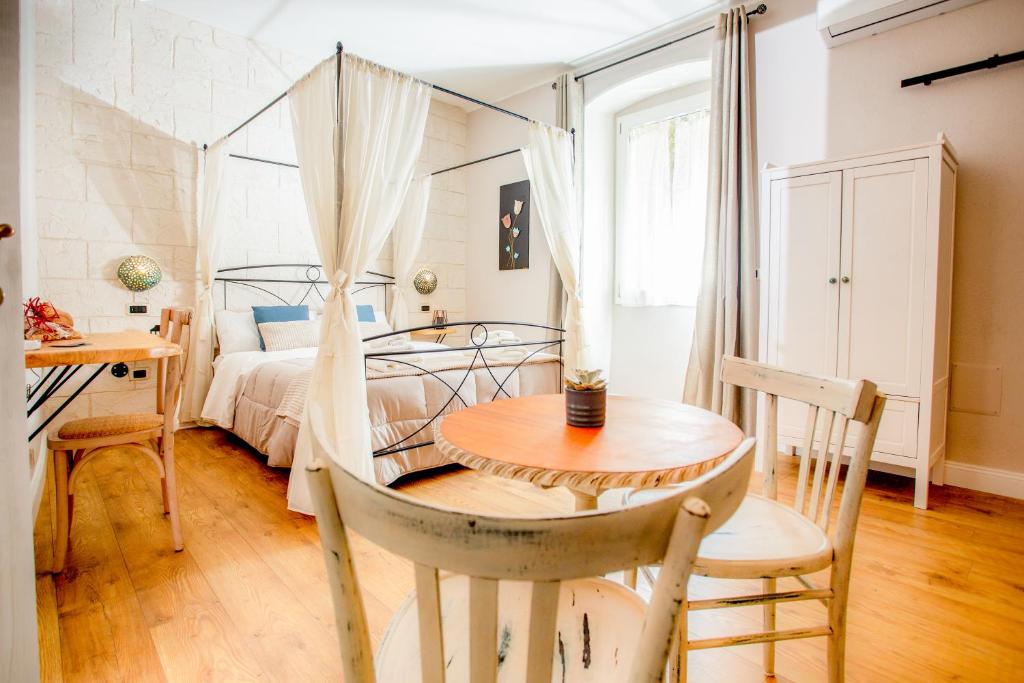 a bedroom with a bed and a table and chairs at L'Accademia dei Sogni in Sassari