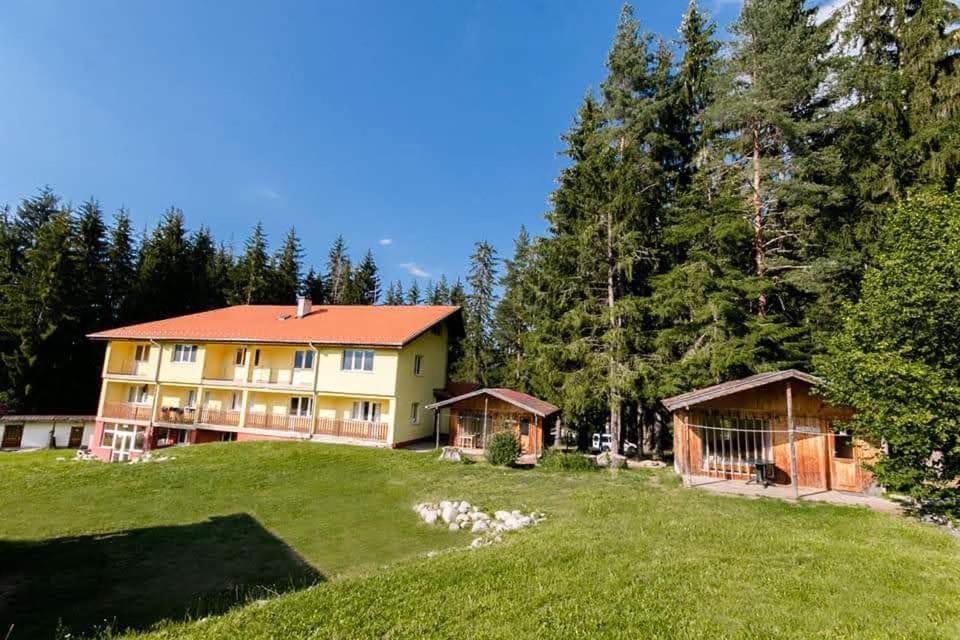 a large house on a hill with trees at BUNGALOWS SKI PISTA Govedarci in Govedartsi