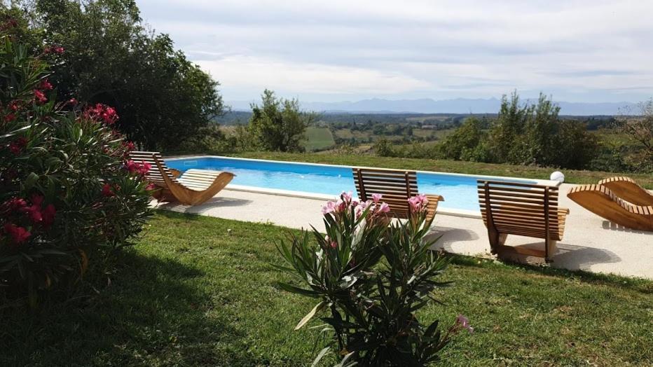 a pool with four chairs in a yard at Magnolia résidence Domaine Cap de Coste in Saint-Frajou