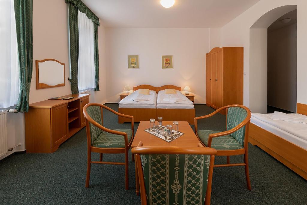 Postel nebo postele na pokoji v ubytování Hotel U Sládka