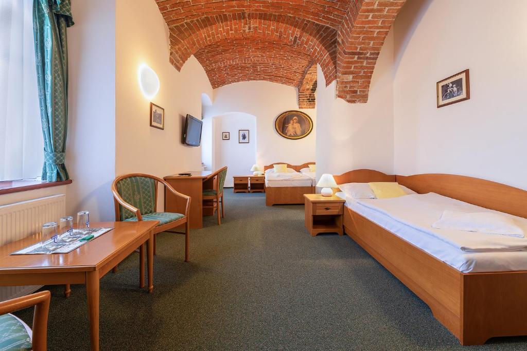 Postel nebo postele na pokoji v ubytování Hotel U Sládka
