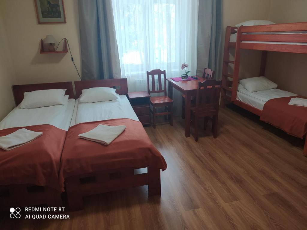 Posteľ alebo postele v izbe v ubytovaní Parkowa Rezydencja Hubal