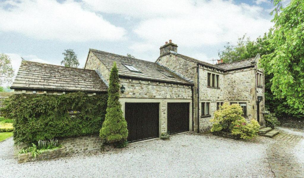 an old stone house with a garage at Cleveliot House in Starbotton