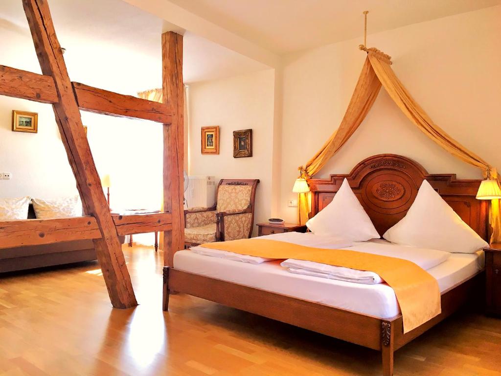 a bedroom with a large bed with a wooden frame at Hotel Rathausglöckel in Baden-Baden