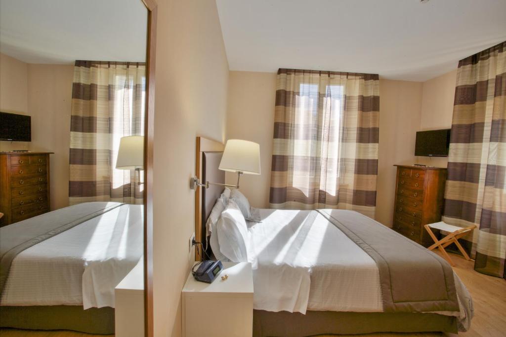 Postel nebo postele na pokoji v ubytování Relais Le Felci Executive Suite Spa
