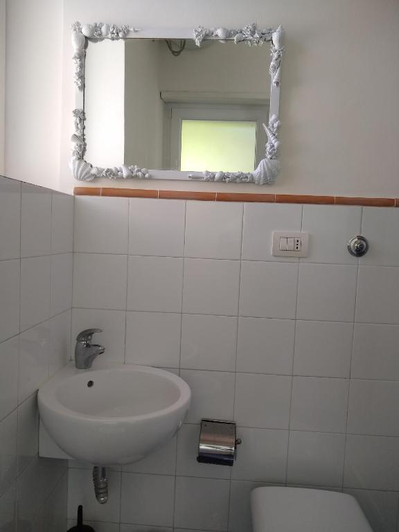 a bathroom with a sink and a mirror at Soleluna in Capri