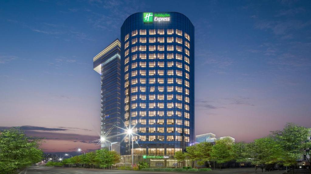 a tall building with a sign on the top of it at 北京亦庄通明湖智选假日酒店 in Beijing