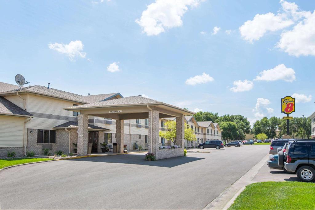 a parking lot in front of a building with a gazebo at Super 8 by Wyndham Brookings in Brookings