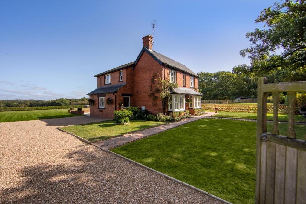 a brick house with a gate in front of a yard at Luxury Four Bed Country House With Hot Tub - Woodchurch near to Ashford in Ashford