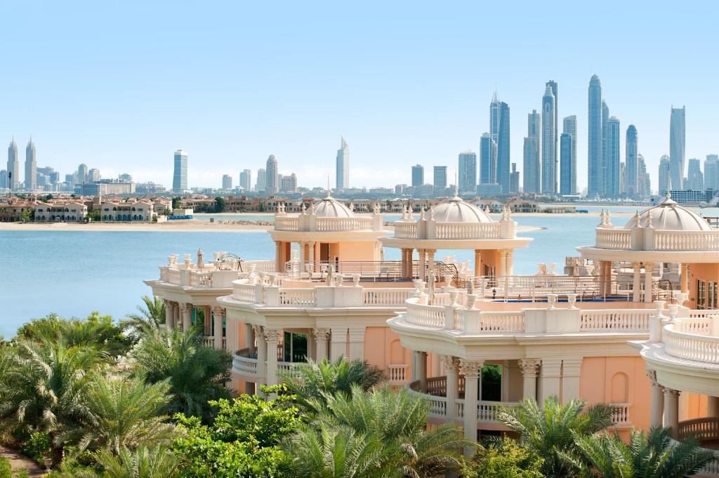 a view of a building with a city in the background at Kempinski Hotel Palm Jumeirah in Dubai