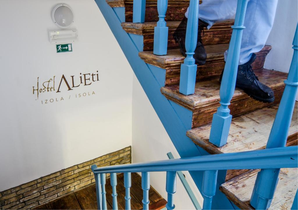 a person walking down the stairs of a house at Hostel Alieti in Izola