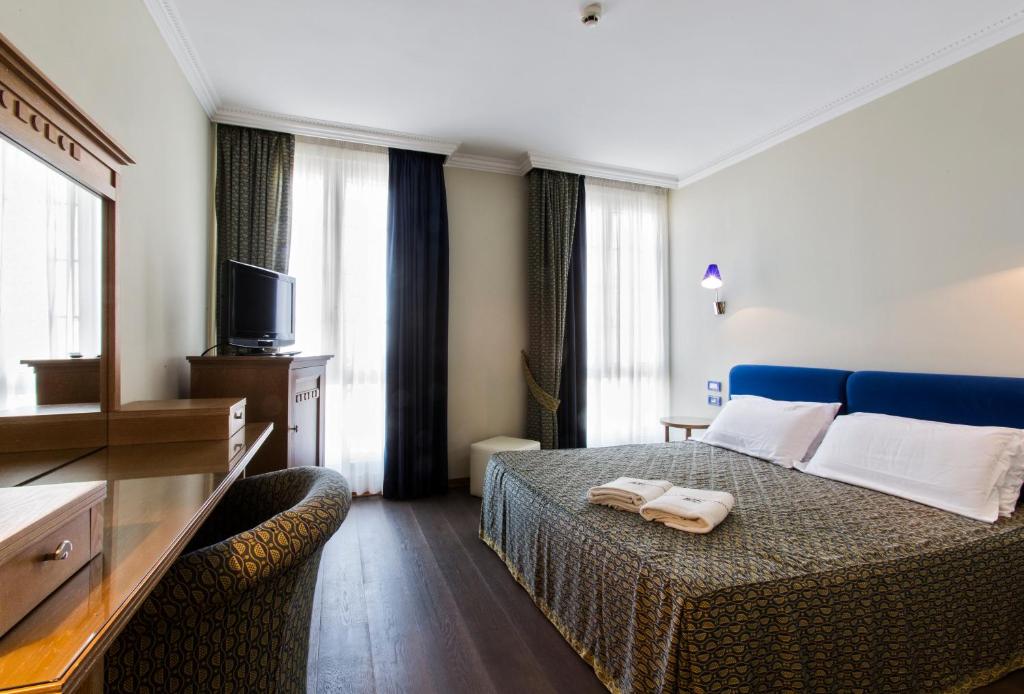 Postel nebo postele na pokoji v ubytování Grand Hotel Cesenatico