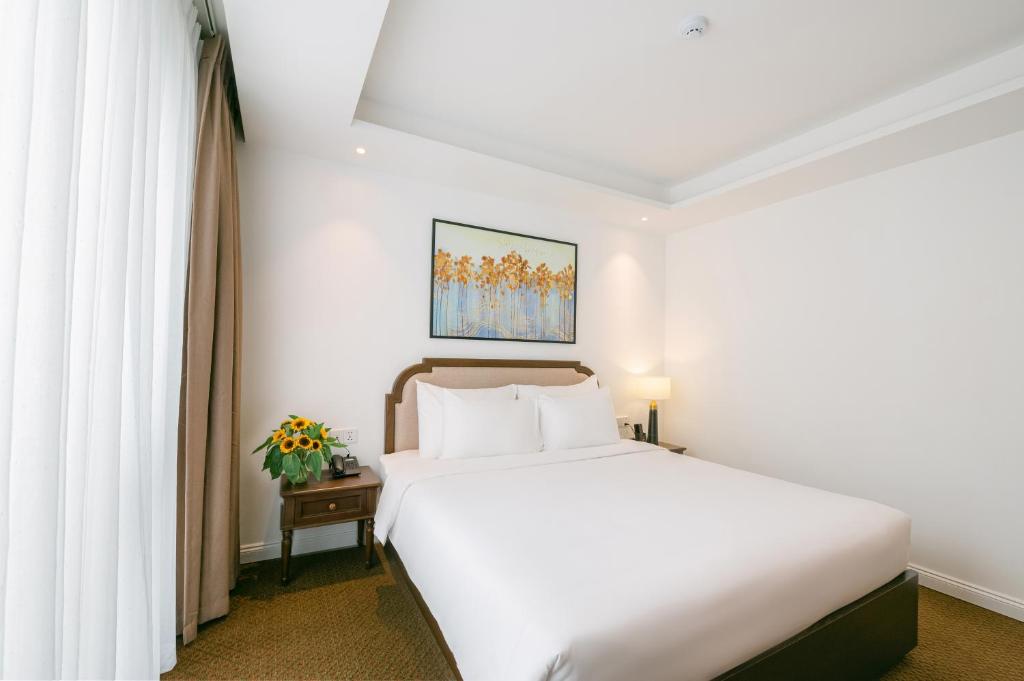 Postel nebo postele na pokoji v ubytování Marigold Hotel Hanoi