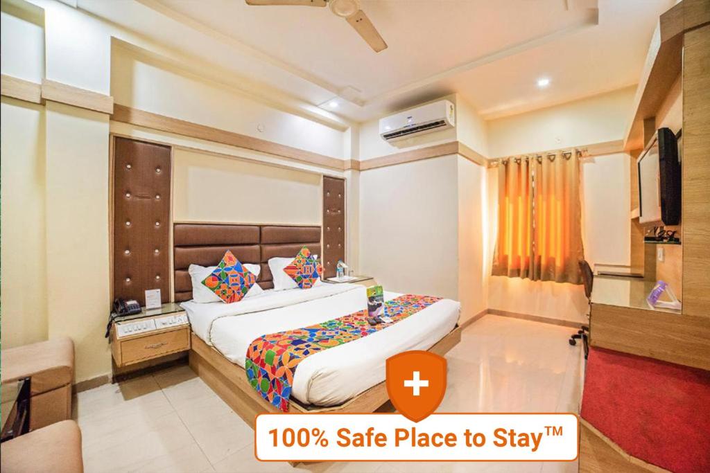 a hotel room with a bed with asafe place to stay at FabHotel Santoor Geeta Bhawan Square in Indore