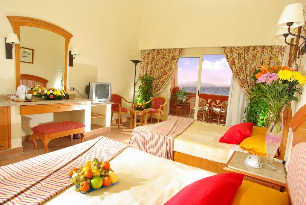 A bed or beds in a room at Sharm Grand Plaza Resort - Families and Couples Only
