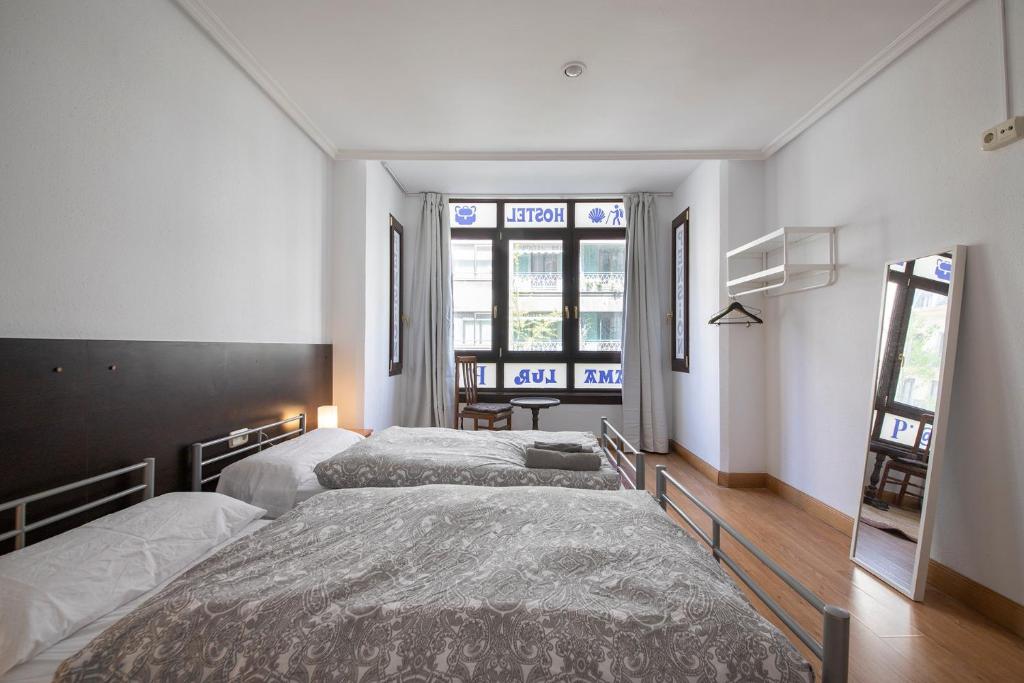 Posteľ alebo postele v izbe v ubytovaní Kontxa Guesthouse