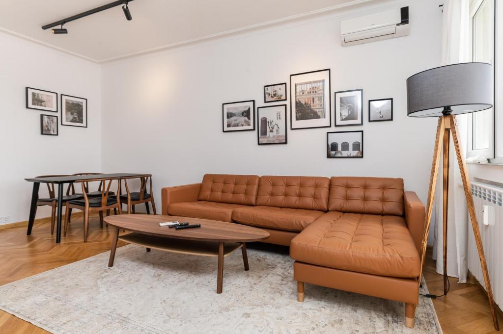 a living room with a couch and a table at Industrial 2-BDR Flat by the National Stadium in Sofia