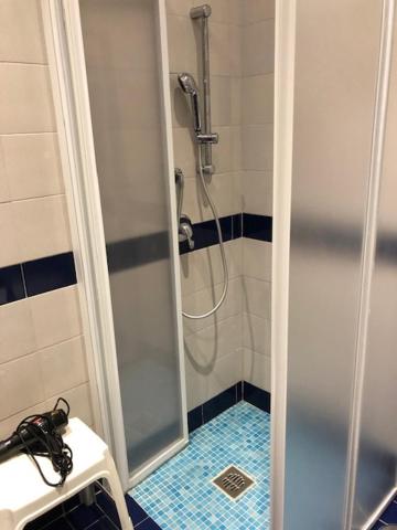 a bathroom with a shower with a glass door at Hotel River Palace in Terracina