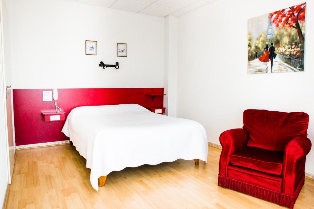 a bedroom with a white bed and a red chair at Pension Gérard in Bourbonne-les-Bains