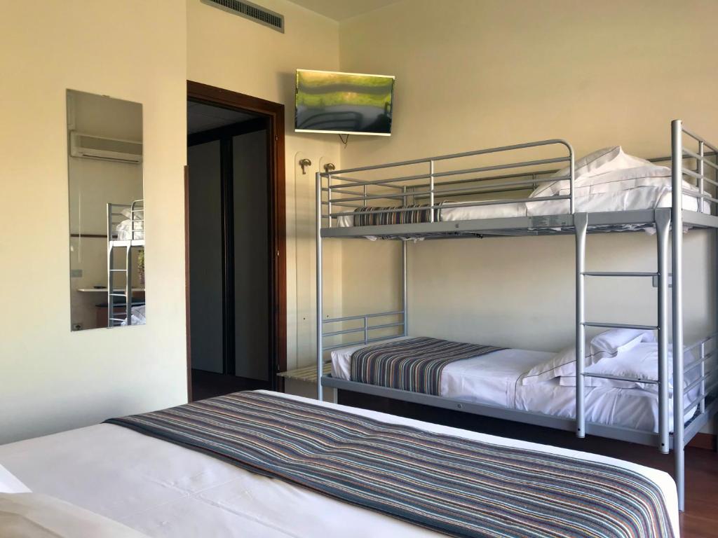 a room with two bunk beds and a doorway at Hotel River Palace in Terracina
