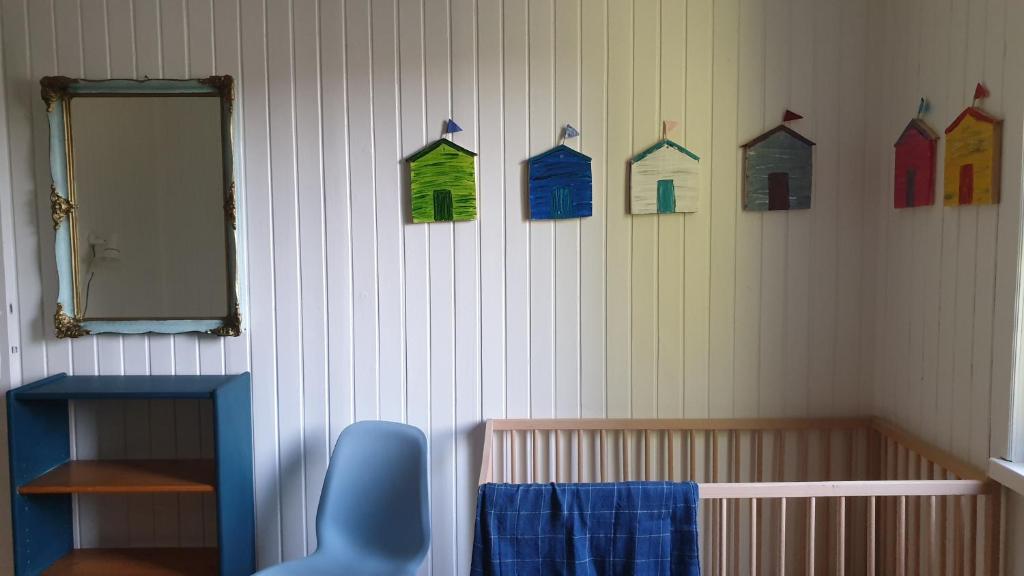巴拉頓菲茲弗的住宿－MiLa Home Balaton，一间设有壁挂、婴儿床和镜子的房间
