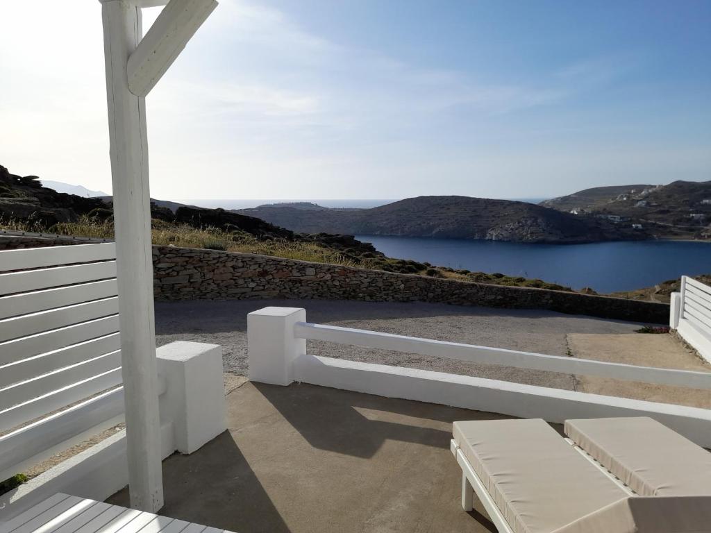 a porch with a bench and a view of the water at Romantic loft 2 in Ios Chora