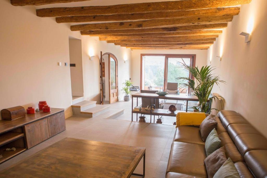 a living room with a couch and a table at Masia Les Apieres in El Pla de Manlleu