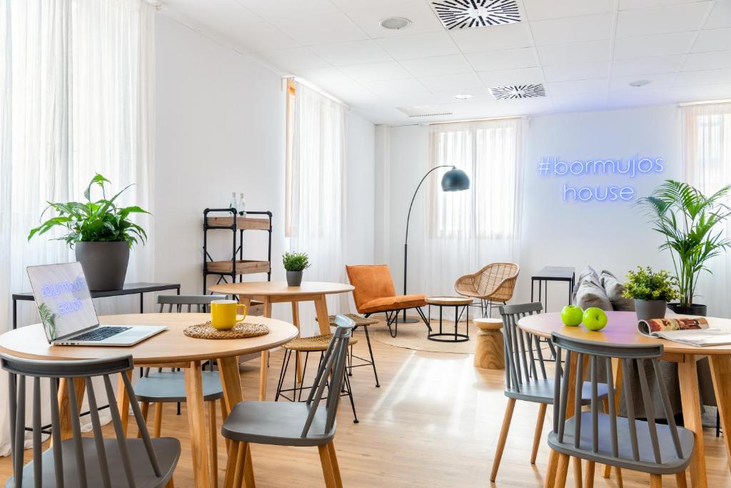 a room with tables and chairs and a laptop at Micampus Bormujos in Bormujos