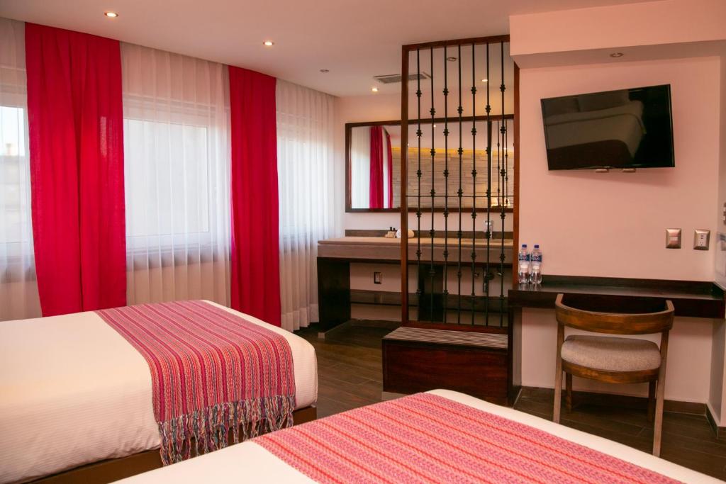 Postel nebo postele na pokoji v ubytování Hotel Alameda Centro Historico