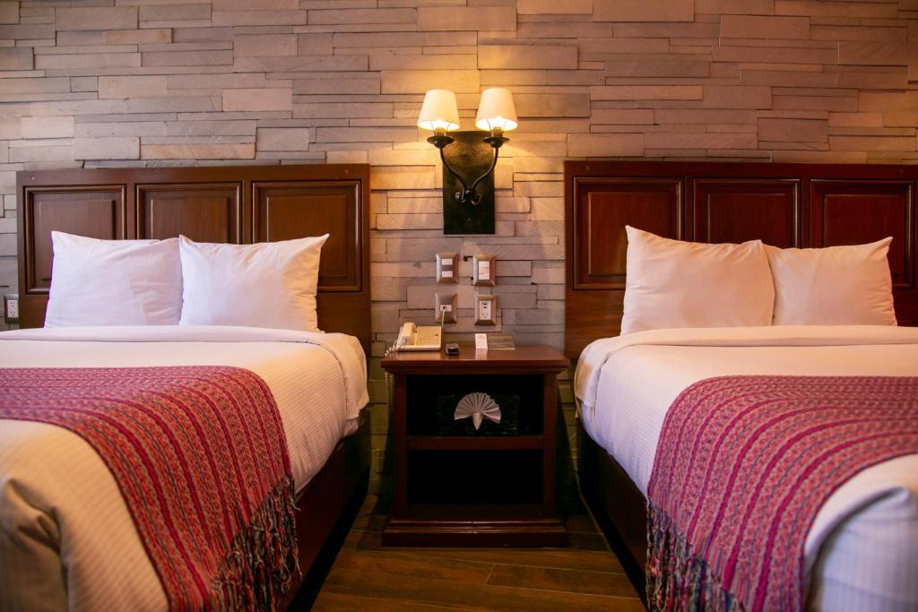 Postel nebo postele na pokoji v ubytování Hotel Alameda Centro Historico