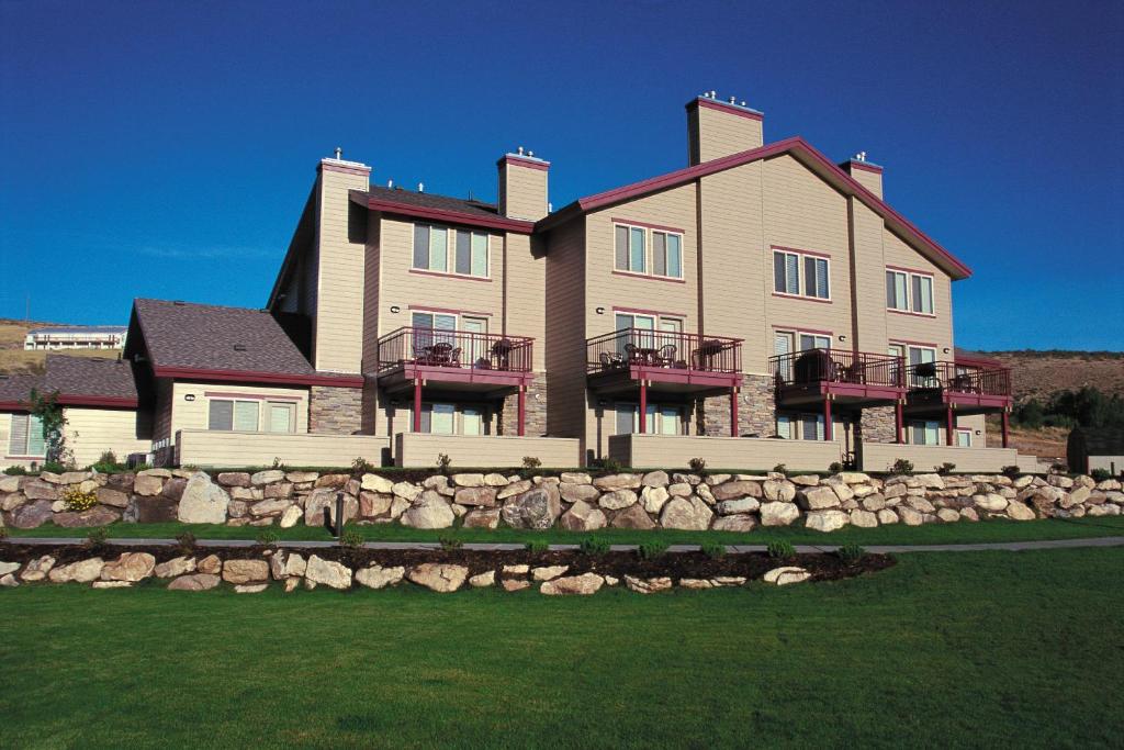 a large house with a stone fence in front of it at WorldMark Bear Lake in Garden City