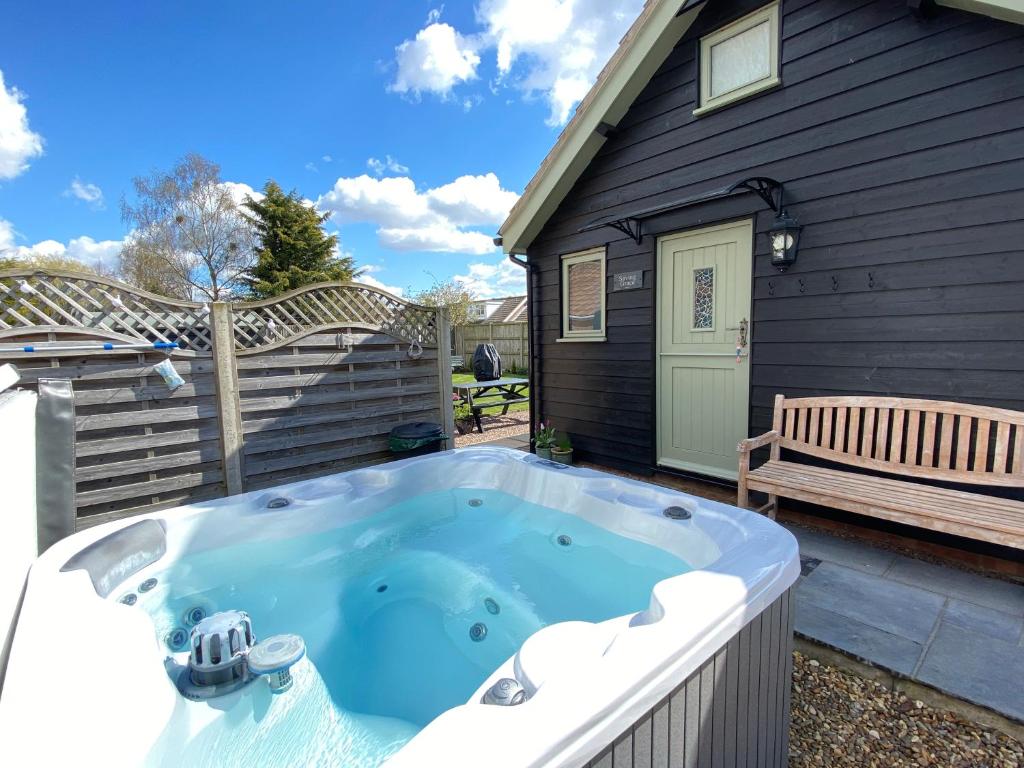 a hot tub in the backyard of a house at Saving Grace with private hot tub in Bawdeswell