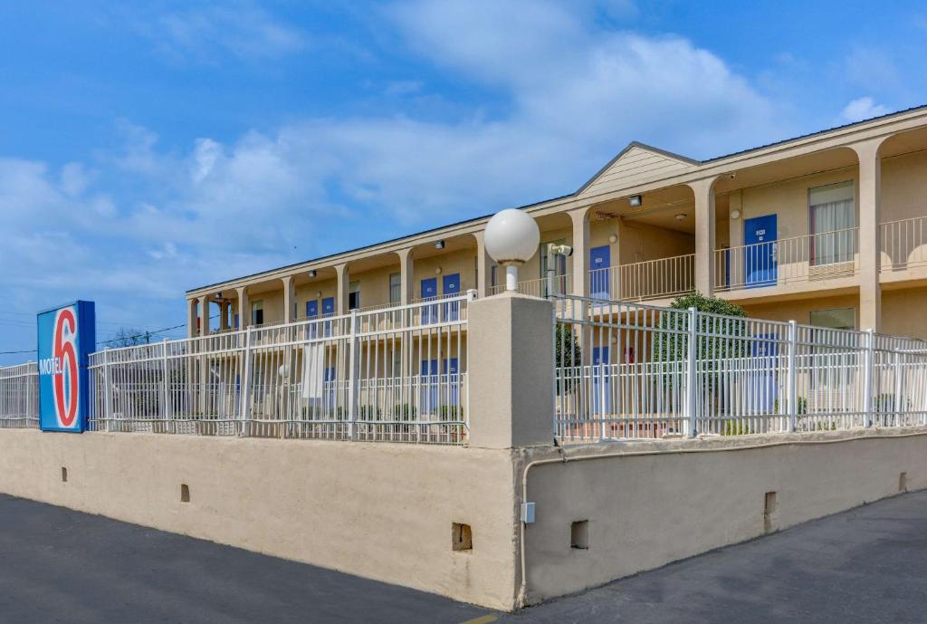 a building with white balconies on a street at Motel 6-Americus, GA in Americus
