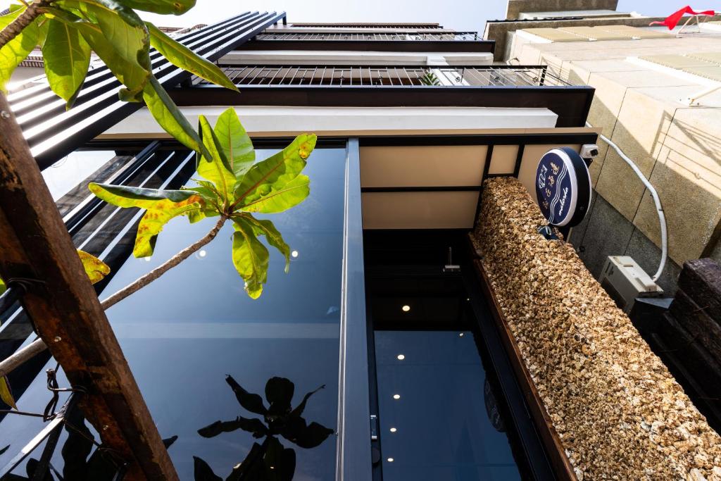 a view from the outside of a building with a fish pond at Marbordo B&B in Xiaoliuqiu