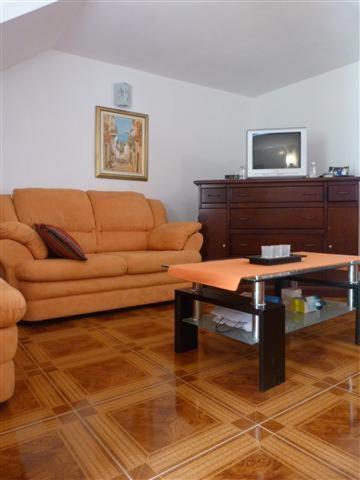 a living room with a couch and a coffee table at Apartments Zukanovic in Fažana