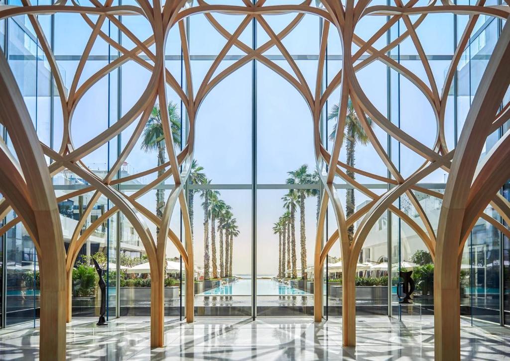 a rendering of the lobby of a building with tall windows at Five Palm Hotel and Residence - Platinium Dubai in Dubai