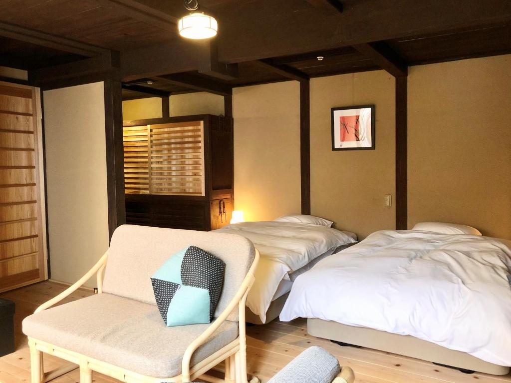 Postel nebo postele na pokoji v ubytování Kariya Ryokan Q