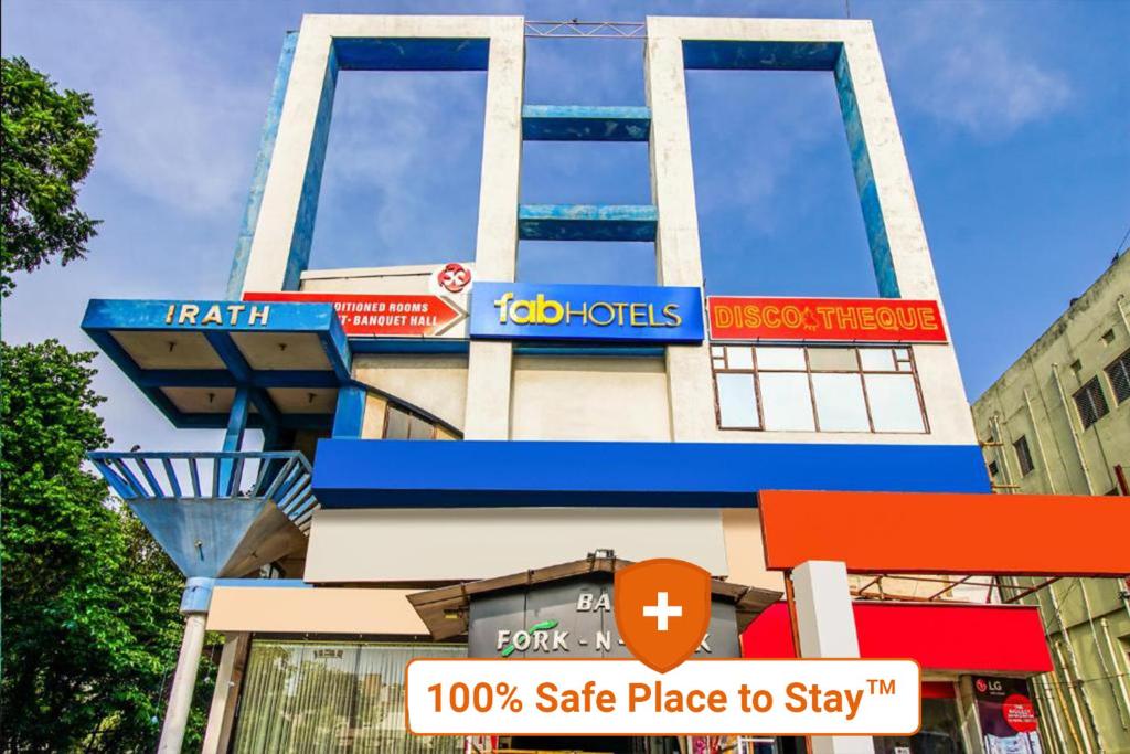 a building with signs on the side of it at FabHotel Palash Residency Ranchi Railway Station in Rānchī