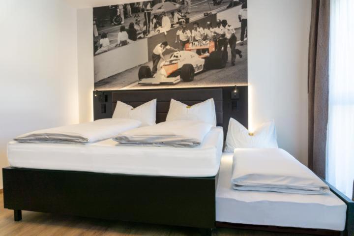 A bed or beds in a room at RINGRAST das Erlebnishotel beim Red Bull Ring